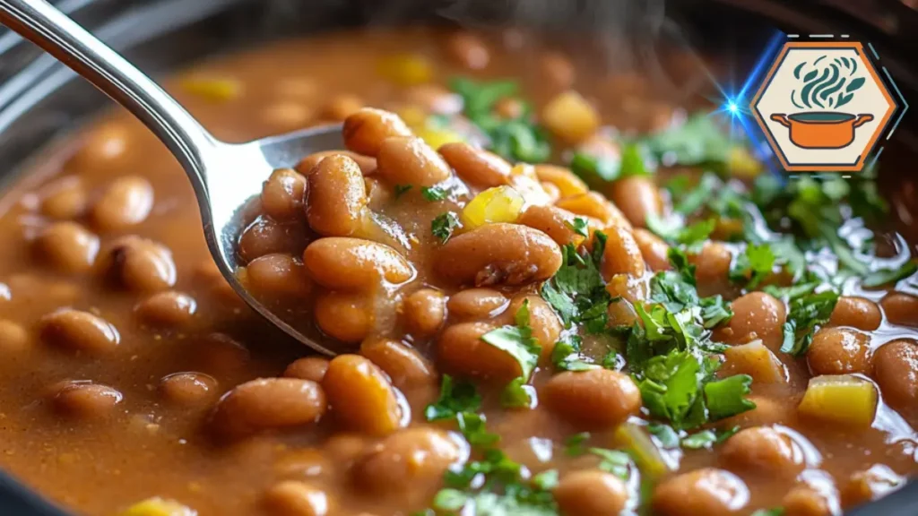Close-up of a spoon scooping tender pinto beans from a crock pot, highlighting their rich texture and slow-cooked flavor.