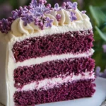 Ultra-detailed slice of Purple Velvet Cake with creamy frosting layers and a vibrant purple crumb, served on a dessert plate.