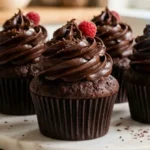 Chocolate Fudge Cupcakes with glossy chocolate frosting on white marble in an American kitchen