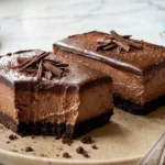 Two-Ingredient Chocolate Cheesecake Bars on white marble countertop