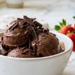 Two-Ingredient Chocolate Ice Cream in a white bowl on marble countertop.