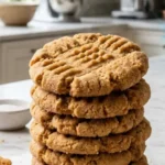Two-Ingredient Peanut Butter Cookies stacked on white marble countertop