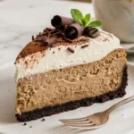 Creamy Coffee Cheesecake with espresso filling, chocolate cookie crust and whipped cream.