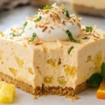 Orange Pineapple Cream Dream sliced into creamy dessert bars with fresh oranges and pineapple on a white marble kitchen island.