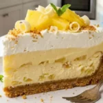 Bakery-style Pineapple Cheesecake Lush with creamy layers on a white plate.