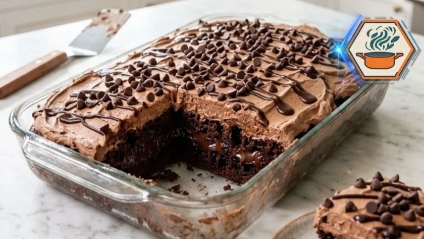 Ultimate Chocolate Poke Cake with whipped chocolate frosting in a glass baking dish
