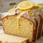 Best Lemon Yogurt Cake with lemon glaze on a white marble countertop