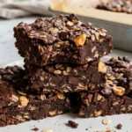 Chewy chocolate peanut butter oat bars with oats and dark chocolate in a baking pan