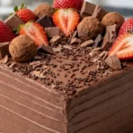Chocolate Strawberry Truffle Cake topped with fresh strawberries, chocolate truffles and milk chocolate.