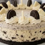 Cookies & Cream Cloud Cheesecake with a slice removed on a white marble kitchen counter