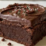 Fudgy holiday chocolate brownies with ganache and festive sprinkles