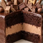 Loaded Chocolate Candy Cake with chocolate cream filling and ganache on a white marble counter