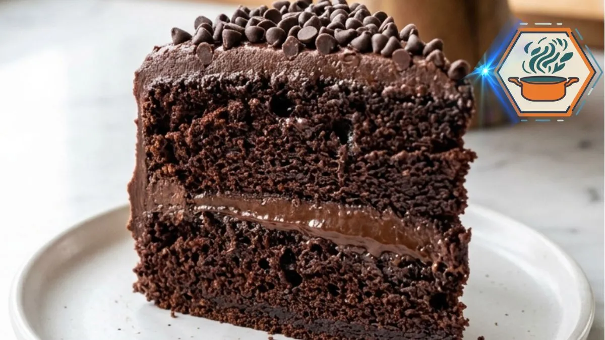 Triple Chocolate Fudge Cake with glossy chocolate frosting and a slice removed