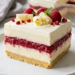White Chocolate Raspberry Cheesecake Lush served on a white plate with creamy cheesecake layers and fresh raspberries.
