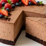 Chocolate Berry Mousse Cheesecake with strawberries and blueberries on a thin chocolate cake base