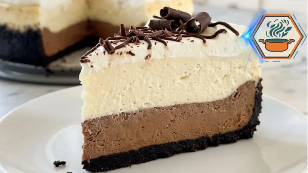Triple Chocolate Vanilla Mousse Cheesecake with chocolate crust, vanilla mousse, whipped cream and chocolate curls